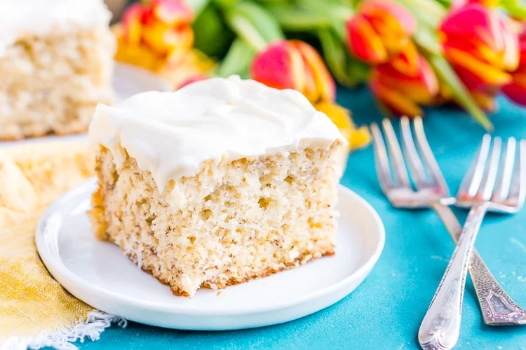This is the Best Banana Cake recipe EVER! It's moist and sweet and topped with a tangy cream cheese frosting!