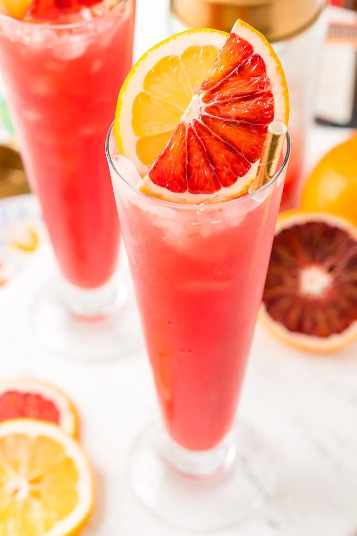 This Blood Orange Cocktail made with blood oranges, gin, lemon juice, citrus bitters, Cointreau, and ice. It's a sexy, fun, and tasty pink drink I call a Citrus Tango!