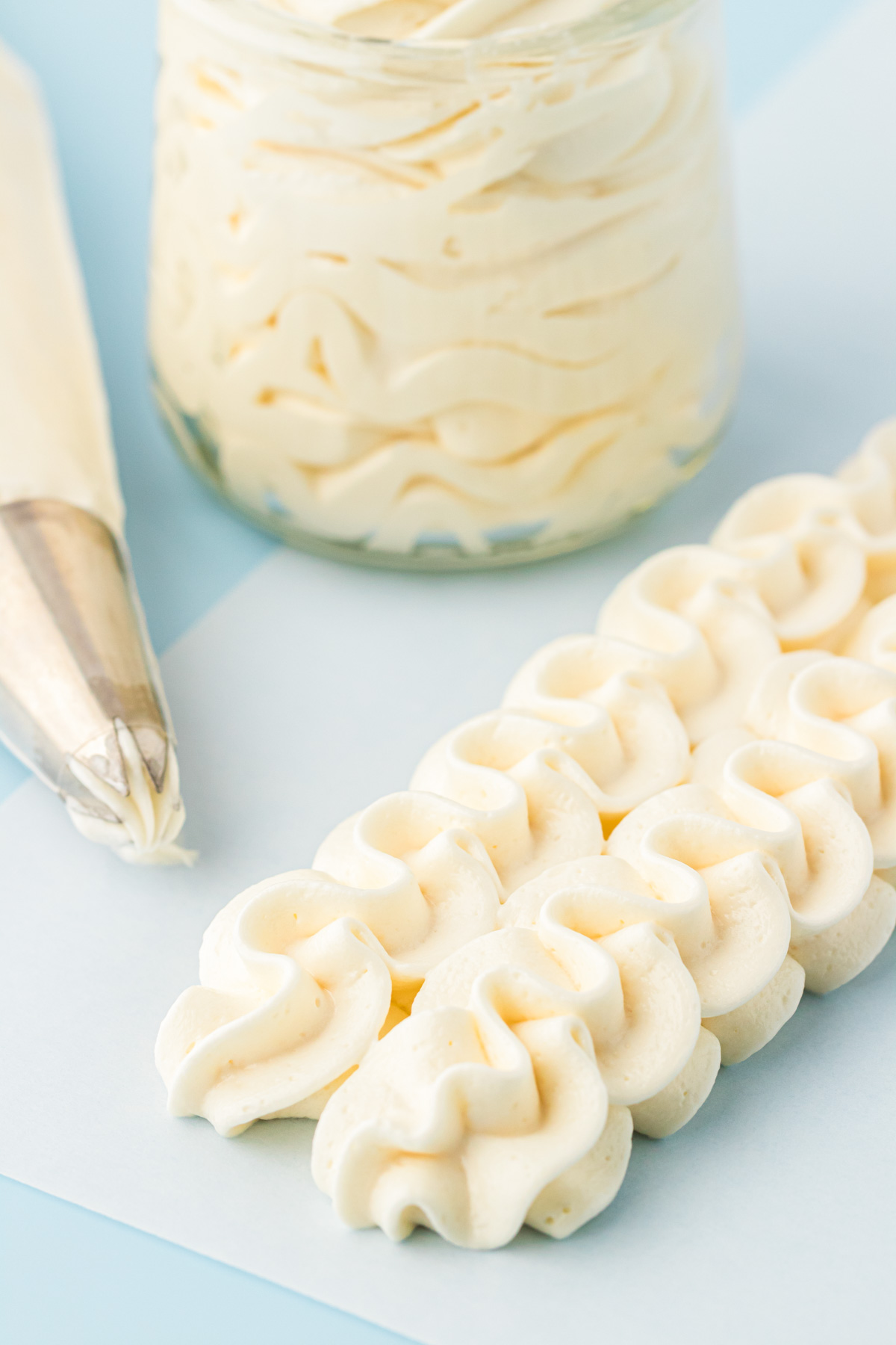 Vanilla American Buttercream Frosting piped onto a piece of parchment paper.