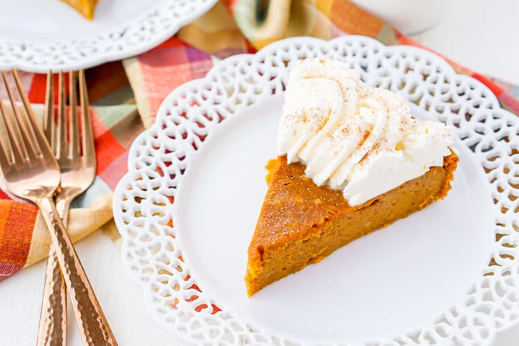 This Impossible Pumpkin Pie Recipe is actually the easiest pumpkin pie you'll ever make! As it bakes, it forms a light crust on its own and leaves behind a dense, but creamy pumpkin filling. Top it with whipped cream and it's the perfect fall dessert!
