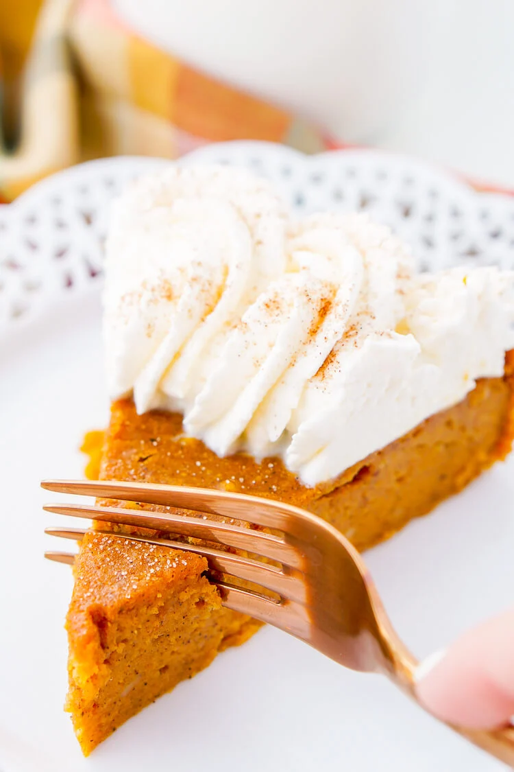 This Impossible Pumpkin Pie Recipe is actually the easiest pumpkin pie you'll ever make! As it bakes, it forms a light crust on its own and leaves behind a dense, but creamy pumpkin filling. Top it with whipped cream and it's the perfect fall dessert!