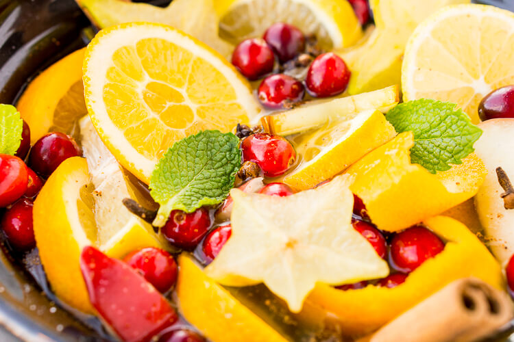 This DIY Holiday Crock Pot Potpourri will have your house smelling amazing all season long with sweet and spicy aromas of cranberries, oranges, mint, cloves, cinnamon, and more!