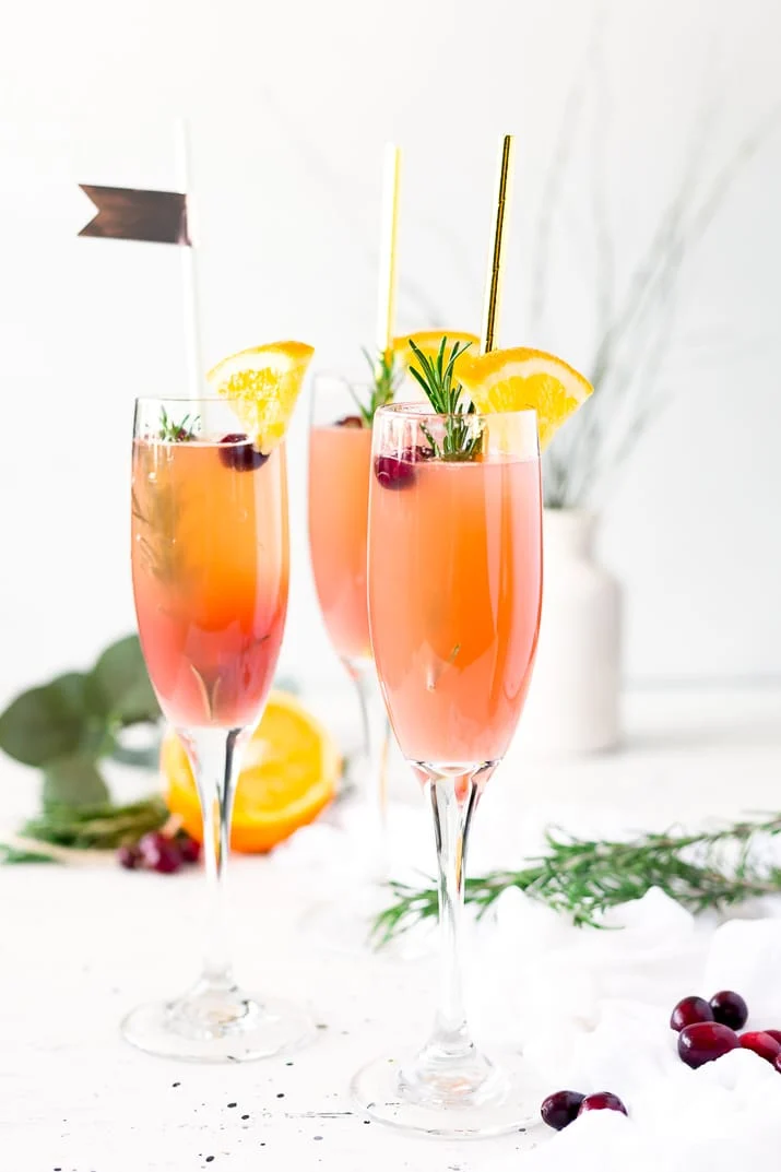 This Cranberry Orange Mimosa is the perfect cocktail for winter brunch! Made with cranberry and orange juice and champagne it's a fruity drink that you can serve up for Christmas or New Year's Eve or any other weekend celebration!