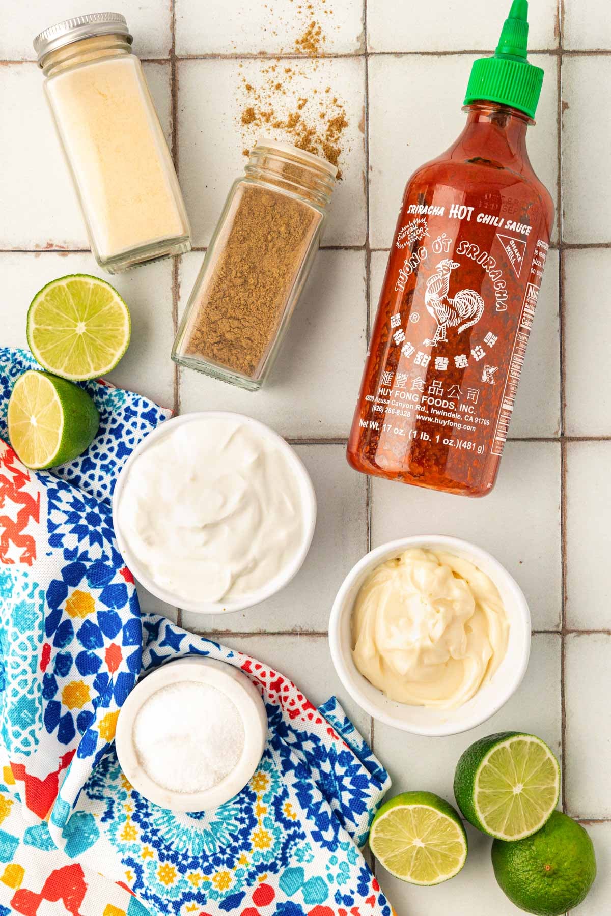 Overhead photo of ingredients to make fish taco sauce on a table.
