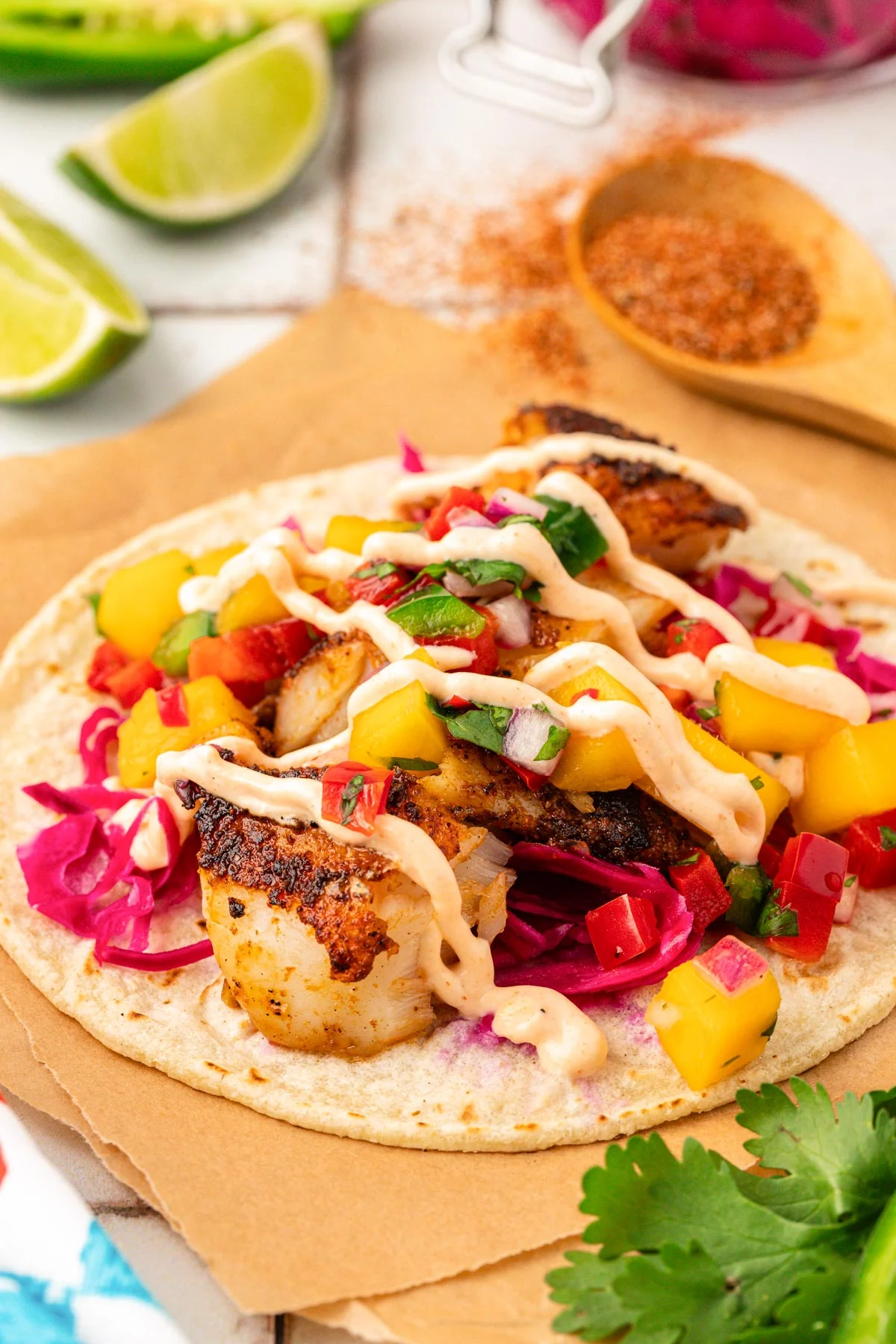 Fish tacos with a drizzle of fish taco sauce on them.