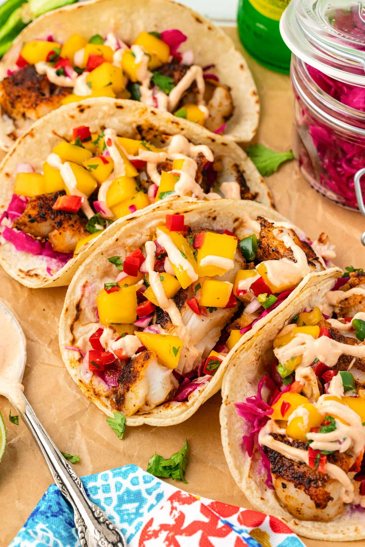 Close up of four blackened fish tacos.