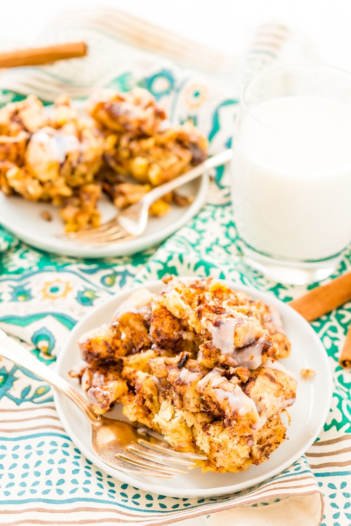 Cinnamon Roll Casserole on plates with fork and milk