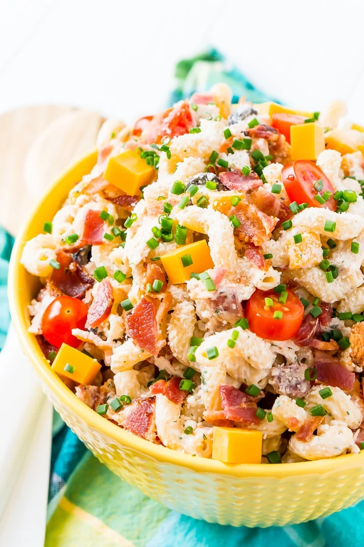 This Chicken Bacon Ranch Pasta Salad is going to be an instant hit at BBQs and picnics this summer! It's loaded with chicken, bacon, cheese, olives, and coated with a delicious ranch dressing.