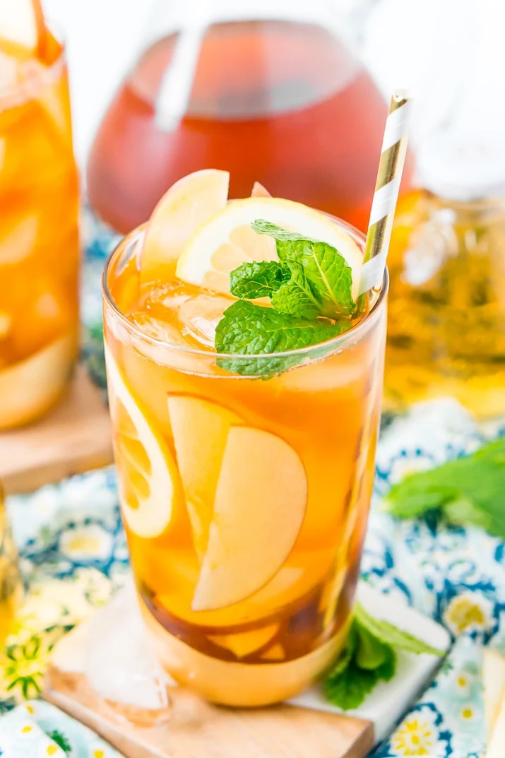 This Homemade Apple Iced Tea is made with freshly brewed black tea, sweet apple juice, fresh apple slices, and a squeeze of lemon for a refreshing summer drink that's easy to make. This flavored iced tea is naturally sweetened by the fruit juice and great for a party!