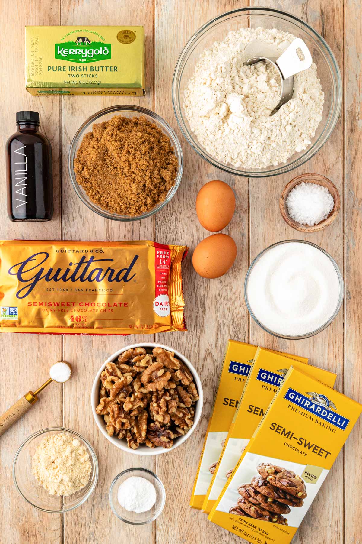 Overhead photo of ingredients on a wooden table to make chocolate chip cookies.