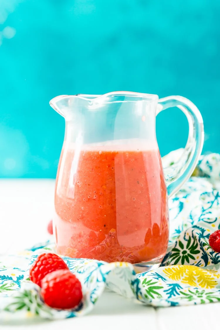Raspberry Vinaigrette Dressing is delicious on summer salads and made with fresh raspberries, honey, red wine vinegar, olive oil, sea salt, black pepper, and garlic powder.