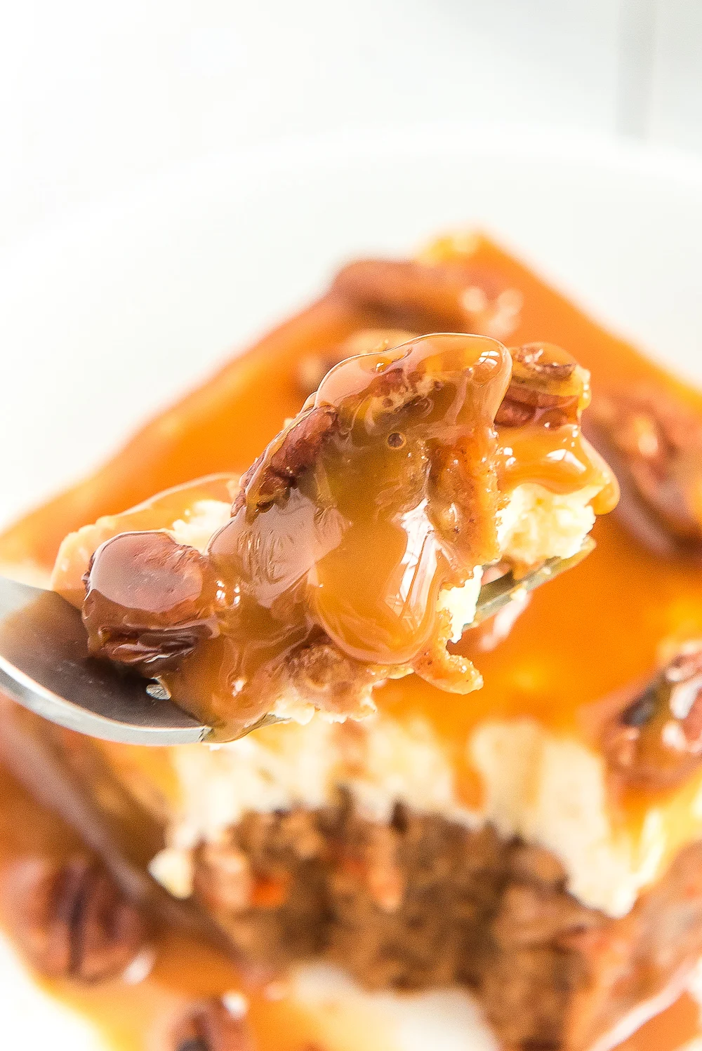 Fork with a bite of Caramel Carrot Cake Poke Cake on it.