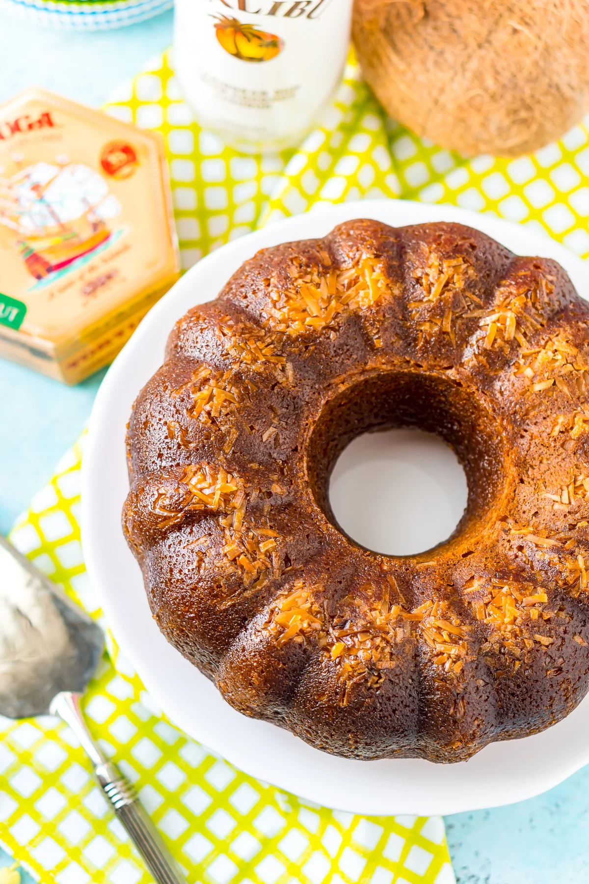 Overhead shot of a bundt rum cake on a white cake stand.