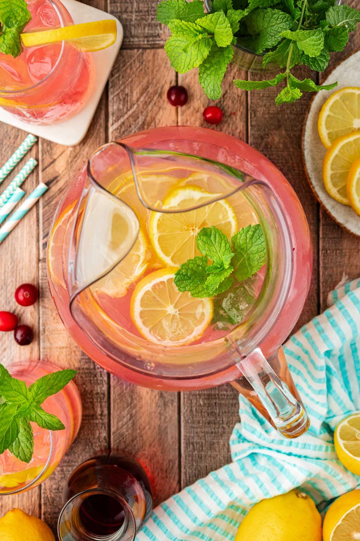 Overhead photo of a pitcher of pink lemonade on a table.