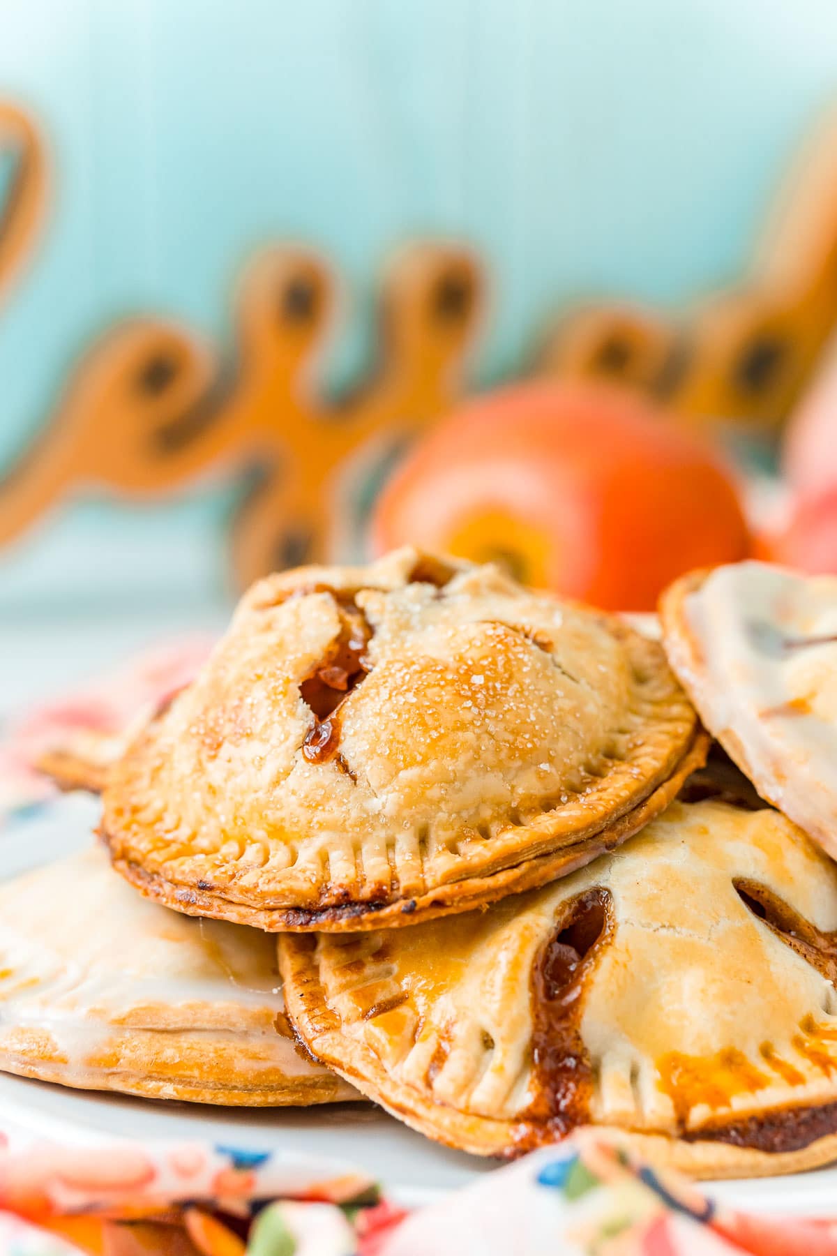 Hand pies piled on a white plate.