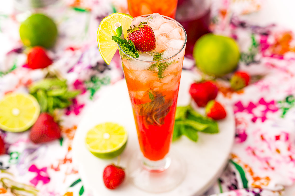Wide photo of cocktail glass filled with strawberry mojito.