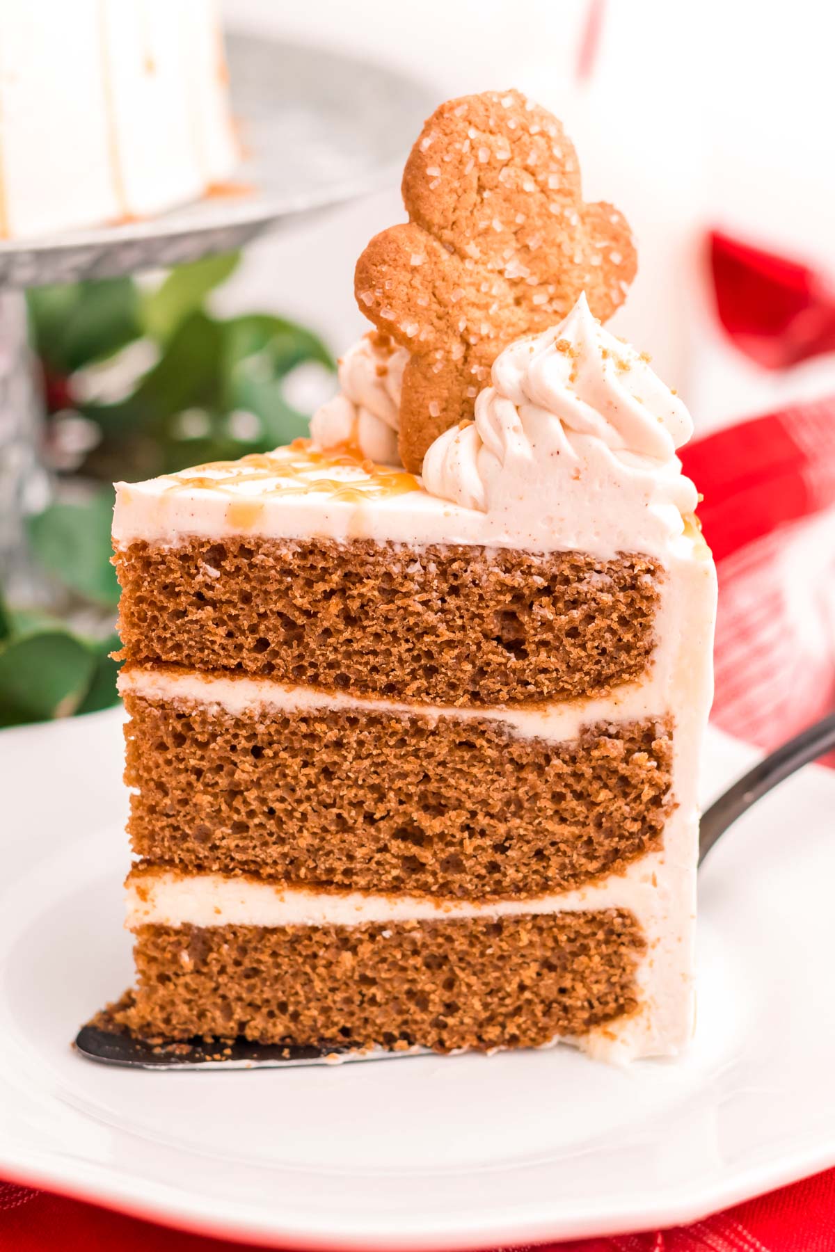 A slice of gingerbread cake on a white plate.