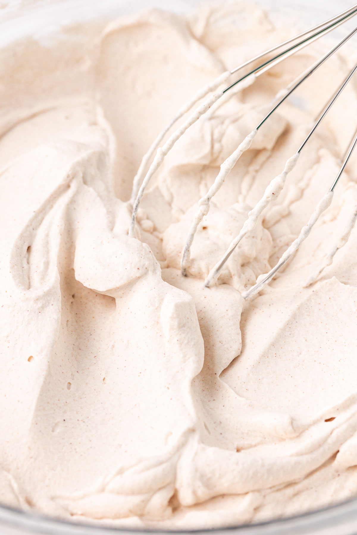 Whipped cream with cinnamon in a bowl.
