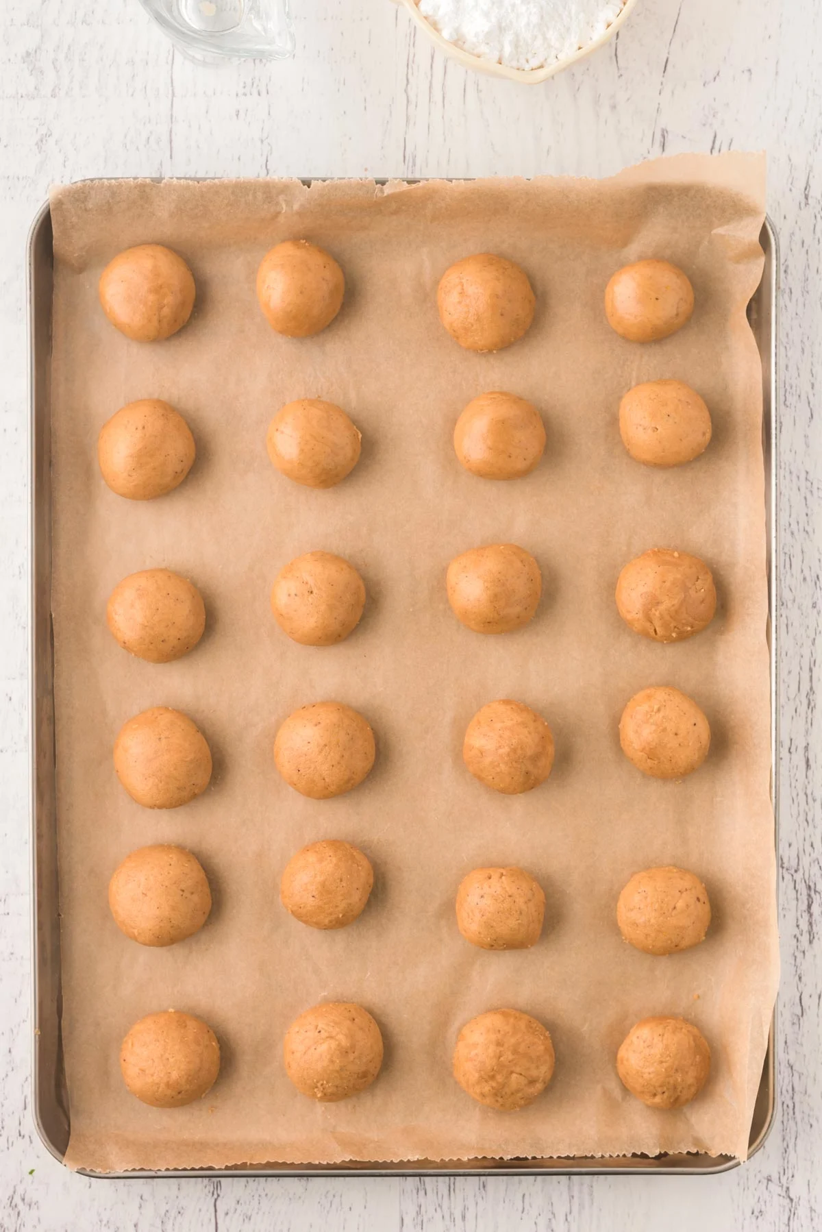Overhead photo of spice cookies on a parchment lined baking sheet.