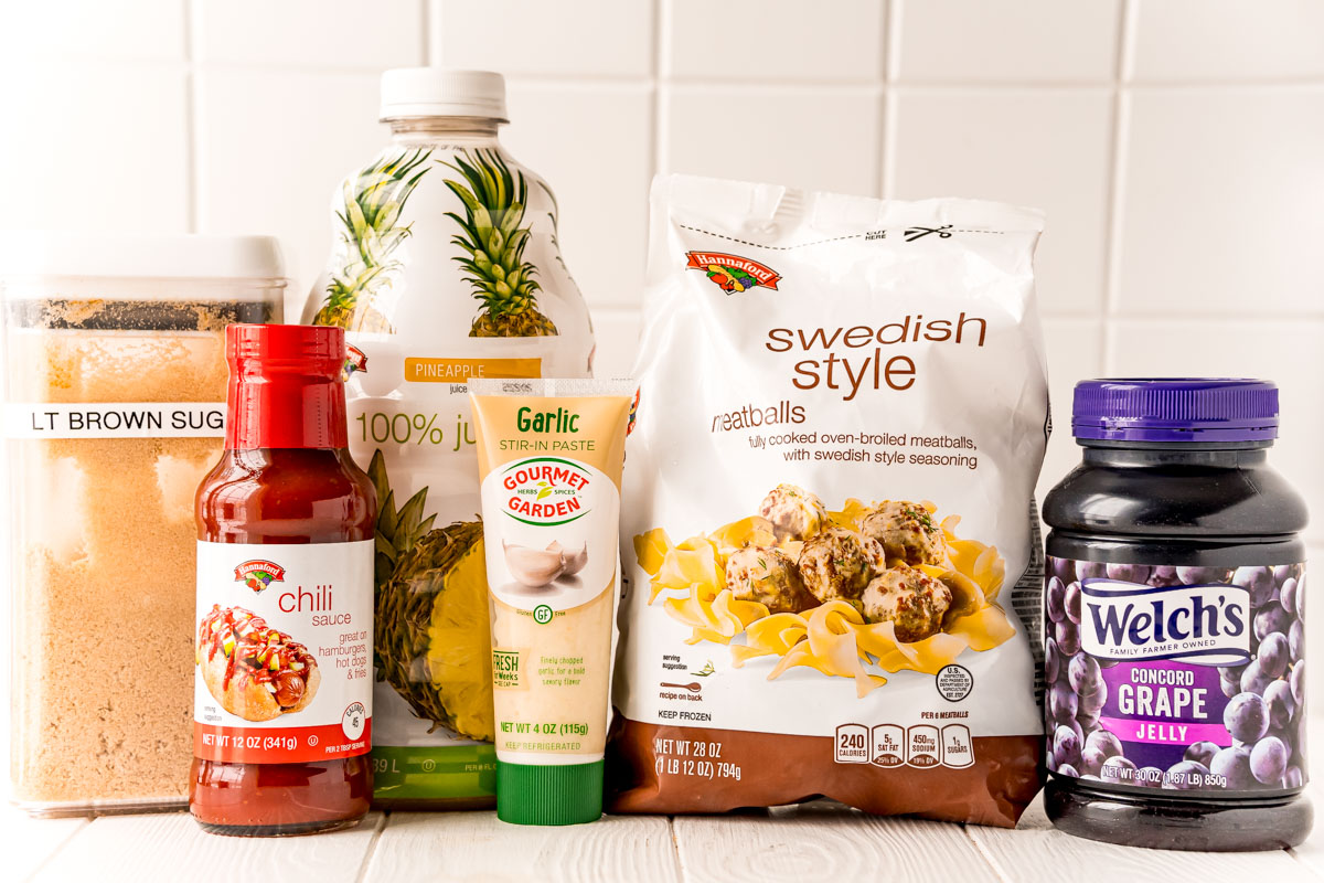 Ingredients used to make grape jelly meatballs on a white table.